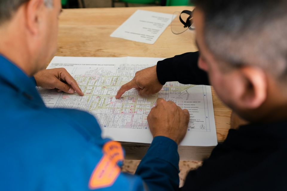 Consultants planning over a large printed map