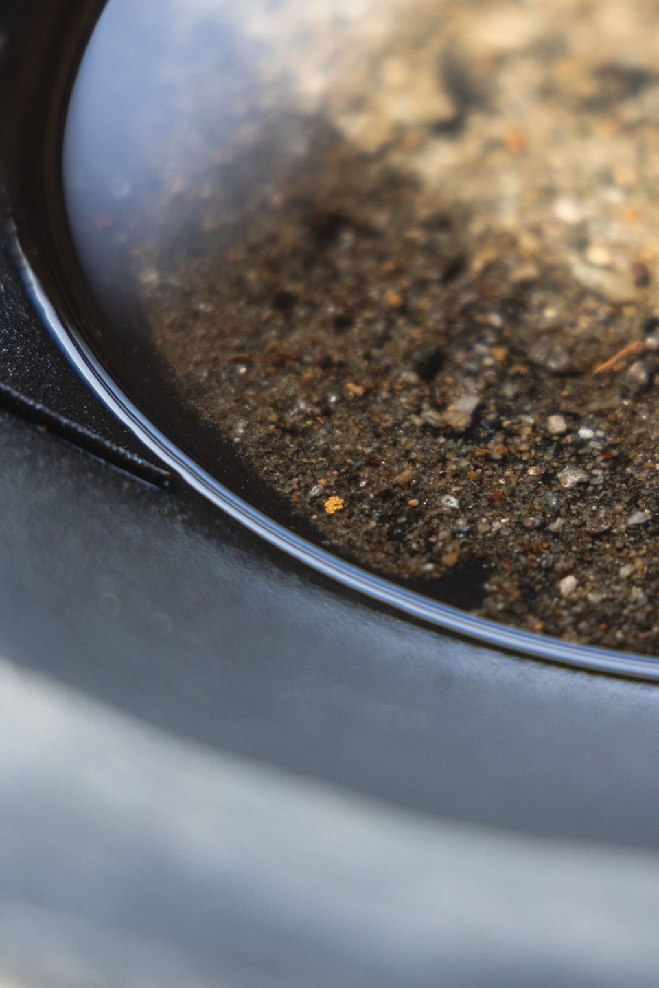 Gold showing in a pan of gravel during sampling