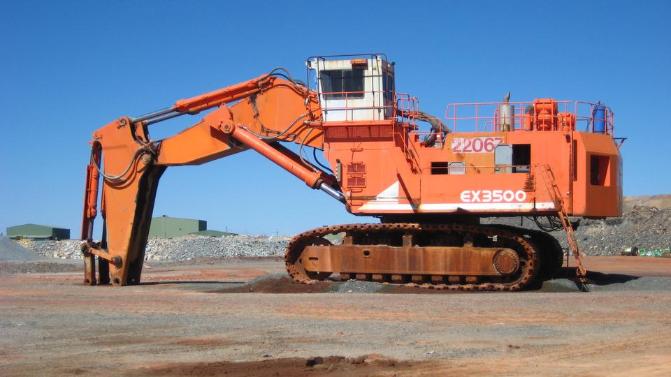 A large hydraulic excavator parked at a gold mine